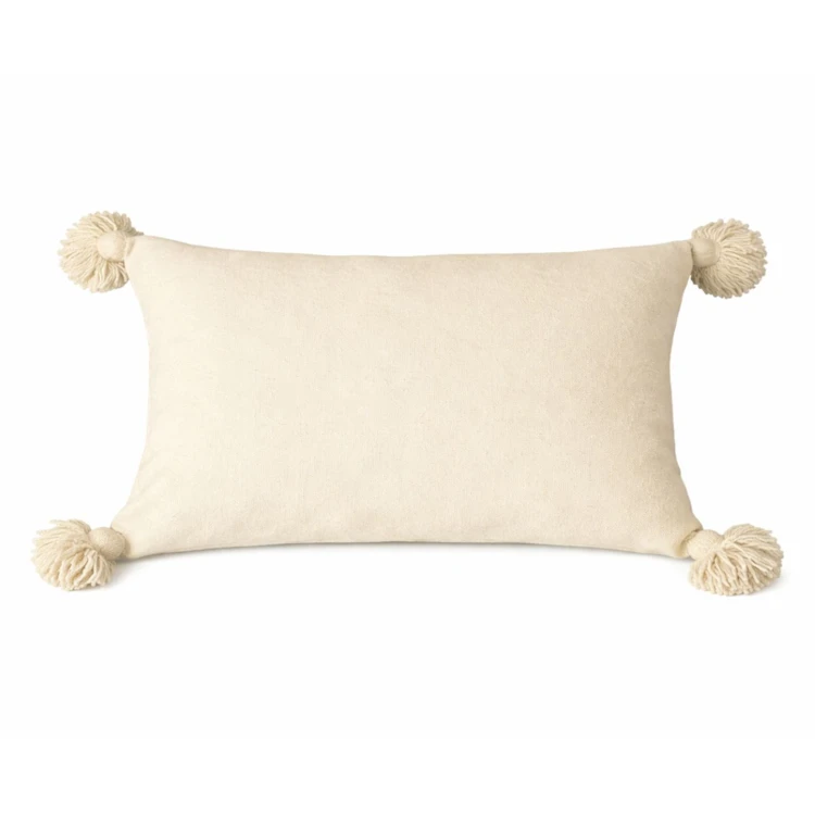 Housse de coussin en laine à pompons